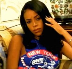 a young woman sitting on top of a couch