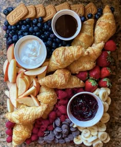 an assortment of fruits and pastries on a platter