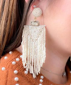 Introducing our Tassel Queen Earrings, a testament to opulent style and meticulous artistry. These earrings exude an air of elegance and grace, adorned with a lavish arrangement of ivory seed beads that come together in perfect harmony.
Embrace your inner royalty as you don the Tassel Queen Earrings, where every detail reflects a commitment to luxurious design. The ivory seed beads delicately shimmer, creating an ethereal and timeless aura that captures the light and draws attention. The tassels Elegant Neutral Drop Earrings, Elegant Natural Color Drop Earrings, Bohemian White Beaded Pearl Drop Earrings, Bohemian White Beaded Earrings With Pearl Drop, Elegant Cream Jewelry With Dangling Beads, White Pearl Beaded Earrings With Dangling Beads, Elegant Beaded Fringe Chandelier Earrings, Cream Beaded Dangle Jewelry, Elegant Beaded Fringe Dangle Chandelier Earrings