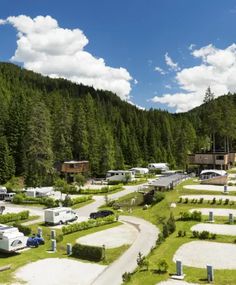 an rv park surrounded by trees and mountains