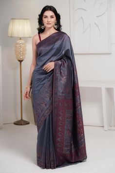 Grey Kani Jamawar saree in silk fabric is very thoughtfully accentuated with Kani weaving in gorgeous flamingo patterns over the borders and pallu along with traditional floral motifs. A spray of zari woven into the saree enhances touch of luxury to this gorgeous piece. .  It is accompanied with Kani Jamawar blouse piece in same colour to complete the look. Kani is an ancient and traditional craft of Kashmir that is traced back to 3000 BC. We try to preserve the uniqueness and charm of this craf Elegant Festive Pashmina Saree, Pashmina Saree With Pallu Detail, Elegant Pashmina Saree With Pallu Detail, Elegant Pashmina Saree With Pallu, Elegant Handloom Jamawar Pre-draped Saree, Semi-stitched Pashmina Saree With Pallu, Pashmina Saree With Zari Work In Traditional Drape, Traditional Pashmina Saree With Zari Weaving, Pashmina Saree With Zari Weaving