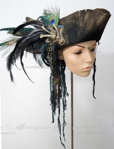 + + + Pirate Hat + + + The pirate hat is made of aged premium woolfelt. It is adorned with bones, various feathers, chains, buttons and textile materials. The hat is available in sizes between: 54 & 64 Size -> Circumference of your head in cm + + +     + + + Information about the feathers: Feathers are not colourfast and if they get wet it is possible that they change colour a little. Please note this if you come into heavy rain. + + +     + + + I create these hats in the studio "Maskenzauber & Authentic Pirate Hat, Big Pirate Hat, Pirate Hat With Feathers, Decorated Pirate Hat, Pirate Hat Aesthetic, Pirate Hat Diy, Pirate Captain Outfit, Diy Pirate Hat, Pirate Captain Hat