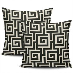 two black and white pillows sitting next to each other