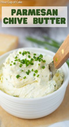 a close up of a bowl of mashed potatoes with parmesan and chives