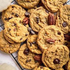 a pile of cookies with pecans and chocolate chips