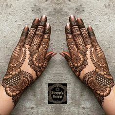 two hands with henna designs on them