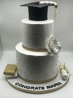 a three tiered cake with a graduation cap on top