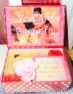 an open pink box with flowers on the inside that says, you are beautiful and there is a note in it