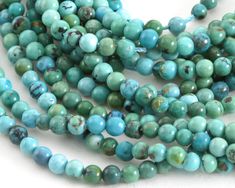 the beads are blue and green with brown spots on each strand, along with other beads