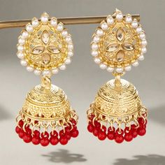 The versatile Cassie Jhumka Earrings are the ideal addition to any collection. Featuring just the right size and delicate details, these earrings can be dressed up or down to suit your style. Embrace their versatility and elevate any outfit with this must-have accessory. *This Product takes a Minimum of 30days to Ship* Red Pearl Earrings For Celebration, Celebration Red Pearl Earrings, Traditional Red Hoop Earrings With Latkans, Traditional Red Chandbali Hoop Earrings, Traditional Red Chandbalis Drop Earrings, Festive Dangle Jhumkas, Traditional Red Pearl Earrings For Party, Traditional Red Hoop Earrings For Celebration, Red Chandbalis With Latkans For Diwali