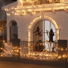 a balcony decorated with christmas lights and decorations