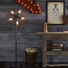 a room with a table, lamp and other items on the shelf next to it