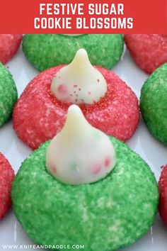 green and red cookies with white frosting on them, in the middle of a plate