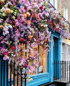 a building covered in lots of colorful flowers