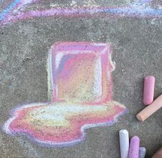 chalk crayons are laying on the ground next to some pastel and pencils