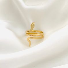 ⭐️Item Details: Ring Height: 25mm Material: 18k Gold Filled Benefits: Water & Tarnish Resistant, Hypoallergenic, Lightweight ⭐️Care Instructions: 1. You may shower and sleep with your gold filled items but it is highly suggested to avoid direct contact with pools, hot tubs, and saltwater. 2. Avoid the jewelry to come into contact with perfume, lotions or any other cosmetic products. 3. Rinse jewelry in warm water at least once a week and gently dry it with a soft cotton cloth to ensure durabilit Gold Snake Shape Rings For Anniversary, Symbolic Gold Midi Rings With Open Shape, Symbolic Gold Midi Rings With Open Ring Design, Symbolic Gold Open Midi Ring, Gold Snake Ring As Gift, Adjustable Gold Snake Ring Symbolic, Adjustable Gold Symbolic Snake Ring, Adjustable Gold Snake Ring Gift, Gold Plated Snake Ring As A Gift