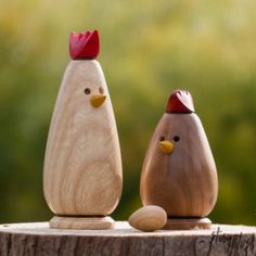 two wooden chickens standing next to each other