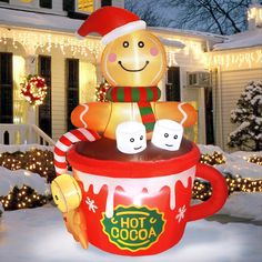 an inflatable coffee cup with marshmallows and a gingerbread man on top