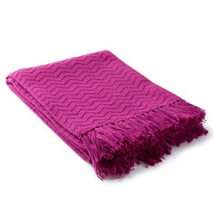 a bright pink throw blanket with fringes on the edges and an intricate design in the middle