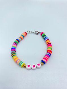 a colorful bracelet with two hearts on it