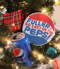 a christmas tree with a pepsi can ornament hanging from it