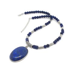 Handmade Lapis Lazuli Beaded Boho Necklace With Large Oval Pendant Made with natural dyed Lapis Lazuli 6 mm round beads and 1 x 0.8 mm barrel beads Tibetan silver spacer beads  Tibetan silver filigree bail Strong silicon-coated steel beading wire Large oval Lapis Lazuli cabochon pendant, size 4 x 3.2 x 0.6 cm (1.57 x 1.25 x 0.23 inches), framed in silver plated metal bezel Silver-plated brass findings Strand length 18 inches ( 45 cm ) + 2 inches extension chain Product Safety Information * Check Handmade Oval Lapis Lazuli Necklace, Bohemian Oval Beaded Necklaces, Bohemian Oval Beaded Necklace, Bohemian Oval Gemstone Bead Necklaces, Bohemian Oval Gemstone Beads Necklace, Oval Hand-strung Beaded Necklaces As Gifts, Oval Hand-strung Beaded Necklace For Gift, Oval Beaded Spiritual Necklaces, Spiritual Beaded Oval Necklace