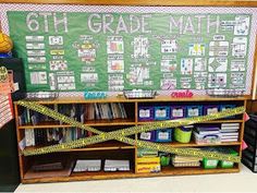 a classroom with a green chalkboard and yellow caution tape on the back of it