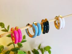 "ENAMEL HUGGIE HOOP EARRINGS - Shape: Circle - Size: 7/8\" - Closure: Huggie Hoop - Color: Black/Gold, White/Gold, Blue/Gold, Pink/Gold - Material: Lead compliant plated metal, Enamel *Please note the product color may slightly vary due to photographic lighting sources or your monitor settings." Candy Pop, Shape Circle, Pop Color, Earrings Colorful, Huggie Hoop Earrings, Photographic Lighting, Jewelry Earrings Hoops, Gold Material, Pink Gold