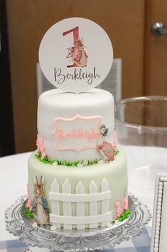 there is a cake with the number one on it and an image of peter rabbit