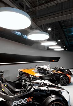 two motorcycles are parked in a large room