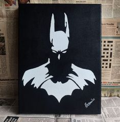 a batman silhouette painted on a black canvas