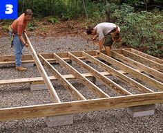 two men are working on building a house