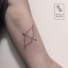 an arrow tattoo on the left arm