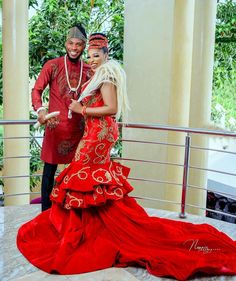 a man and woman dressed in red standing next to each other