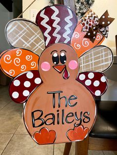 a wooden turkey with the words the baileys painted on it