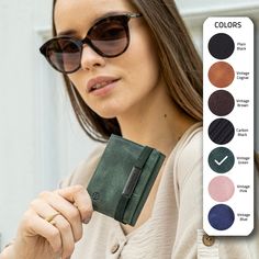 a woman wearing sunglasses and holding an empty wallet with color swatches in front of her