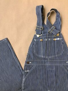 Unworn 60s/70s hickory pinstriped also known as railroad stripe bib overall - the classic workwear with union stamp. Size tag still attached. W26 L34  Waist: 66cm / 26" Front rise: 30cm / 12" Inseam: 88cm / 34.5" Send us a dm if you have questions! For information about our full terms & conditions please review our Shop Policies. Railroad Stripe Overalls Outfit, Pinstripe Overalls, Classic Workwear, Bib Overalls, Union Made, Vintage Pants, Lee Jeans, 70s Vintage, Striped Fabrics