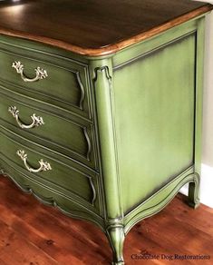 an old dresser painted green with white trim