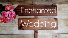 two wooden signs with the words enchanted and forest on them next to pink flowers