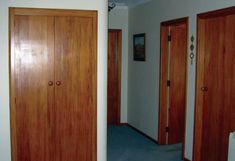 an empty room with wooden doors and carpet