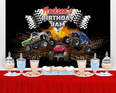 an image of a birthday party with monster trucks on the table and desserts in front of it