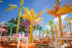 colorful palm trees are lined up on the beach