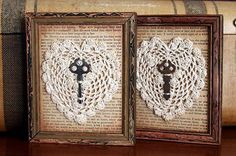 two framed pictures with lace doily and a key on the front one has a heart in it