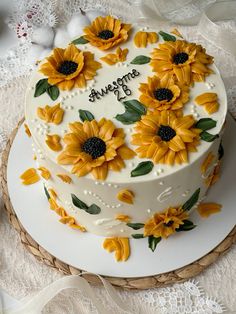 a cake decorated with sunflowers on top of a table