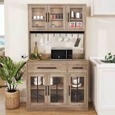 a kitchen area with a microwave, potted plant and other items