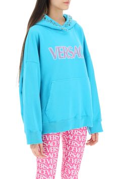 Loop-back cotton jersey sweatshirt by Versace with contrasting lettering logo in a spray effect and studded hood. Kangaroo pocket, ribbed trims and oversized fit. The model is 177 cm tall and wears size 38. Size Info IT Color Detail Light blue Made In Portogallo Material 100% CO Season One spring Season Two summer Product clothing Brand Versace Size And Fit Versace Hoodie, Trench Dress, Jersey Sweatshirt, Workout Sweatshirt, Knitwear Cardigan, Unique Designers, Pant Shirt, Spring Season, Roberto Cavalli