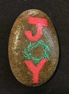 a rock with the word joy painted on it