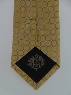 "Men's 100% silk gold necktie is the perfect tie for the big wedding day or everyday. This gold tie available as a extra long Neck Tie. Handmade from 100% silk, this special collection features a .75\" Eds Neckties logo at the bottom right front corner of every tie and a larger logo located on the tipping (Back of the tie). The label features the collection name (Nathaniel Alexandria) Named after my son Nathaniel and my daughter Alexandria. Expertly hand-made from 100% silk you can select your l Elegant Formal Ties For Father's Day, Gold Tie For Father's Day Gift, Gold Tie Gift For Father's Day, Elegant Ties For Black Tie Events And Father's Day, Luxury Gold Suit And Tie Accessories For Formal Occasion, Elegant Black Tie For Father's Day, Classic Gold Tie For Father's Day, Classic Gold Ties For Father's Day, Luxury Gold Tie For Formal Occasions