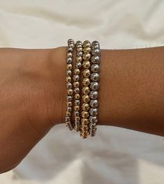 "Perfect worn on its own or layered with our other bracelets. 18k gold and rhodium filled, 4mm beads 6\", fits up to 6.5\" Ready to ship *18k gold filled is a more affordable alternative to solid gold jewelry. Gold filled is a layer of gold bonded onto a base metal with heat and pressure that contains 100+ times more gold than gold plated jewelry.  *It is very durable and tarnish resistant.  *With proper care, gold filled jewelry can last several years. Avoid contact with harsh chemicals, perfumes, water, etc.  *Gold filled jewelry can be worn by people with sensitive skin because it is hypoallergenic, lead free and nickel free." Dainty Silver Bracelets With Gold Beads, Dainty Silver Bracelet With Gold Beads, Dainty Gold Jewelry With Silver Beads, Gold Stackable Rosary Bracelet With Round Beads, Stackable Gold Rosary Bracelet With Round Beads, Gold Beaded Bracelets With Silver Beads For Everyday, Silver Bracelets With Gold Beads For Everyday, Dainty Gold Bracelet With Silver Beads, Elegant Gold Bracelets With Silver Beads