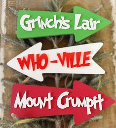 three wooden signs that say grin's fair, who - vile and mount crumpt